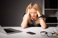 Woman in office holding her head in disgust