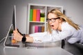 Woman in office holding on to computer