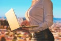 Woman in the office suit with a laptop on the balcony of the office building on the New York city background. Royalty Free Stock Photo