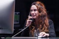 A woman office worker sitting at the desk and working with a computer. The concept of service. Reception in the hotel Royalty Free Stock Photo