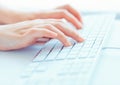 Woman office worker typing on the keyboard