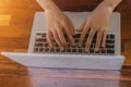 Woman office worker is typing keyboard of laptop with sunlight, business or learning concept Royalty Free Stock Photo