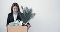 A woman office worker is unhappy with being fired from a company packing things into cardboard boxes. The Young woman was stressed Royalty Free Stock Photo