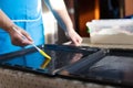 Woman oiling baking sheet with. Baking at home.