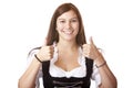 Woman with Oktoberfest Dirndl dress shows thumbs Royalty Free Stock Photo