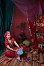 a woman in old Asian traditional outfits is buying in an old oriental shop. oriental bazaar, silk road