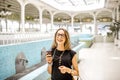 Woman in the old pump room with thermal water Royalty Free Stock Photo