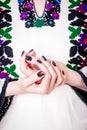 Woman in an old Ukrainian embroidered shirt, fragment. Manicure with black nail polish, copy space Royalty Free Stock Photo