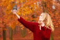 Woman with old vintage camera taking selfie photo.