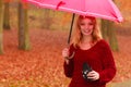 Woman with old vintage camera and umbrella.