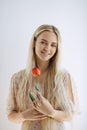 Woman with One Flower Indoors on White Background Royalty Free Stock Photo