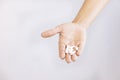 Woman hand holding white pills in hands Royalty Free Stock Photo