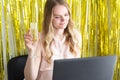 Woman on online corporate party or online dating with a laptop at the table drinks champagne from a glass. Internet celebration, Royalty Free Stock Photo