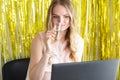 Woman on online corporate party or online dating with a laptop at the table drinks champagne from a glass. Internet event, virtual Royalty Free Stock Photo