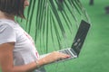 Woman online shopping concept. Freelancer woman in the green park with modern laptop. Bali island. Royalty Free Stock Photo