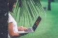 Woman online shopping concept. Woman in the green park with modern laptop. Bali island. Royalty Free Stock Photo