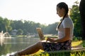 Woman online work outside. Laptop, computer business technology. Student girl working on tablet in summer nature park Royalty Free Stock Photo