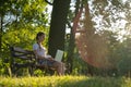 Woman online work outside. Laptop, computer business technology. Student girl working on tablet in summer nature park Royalty Free Stock Photo