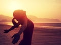 Woman with open arms on sunrise beach Royalty Free Stock Photo