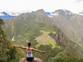 Woman with open arms at the top of Wayna Picchu mountain in Machu Picchu Royalty Free Stock Photo