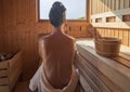 Woman with open back relaxing in the wellness spa, sweating in Finnish sauna Royalty Free Stock Photo