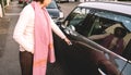 Woman open the door of a new mini car on French street