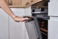 Woman open electric oven door