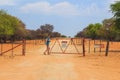 Woman open the gate on gravel road to Waterberg Plateau National Park, Namibia