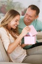 Woman open gift, man and happiness with surprise for birthday or anniversary, love and support with romance. Couple in Royalty Free Stock Photo