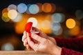 Woman open her gift box jewellery with bokeh led lights background. Valentines day and romance concept. Royalty Free Stock Photo