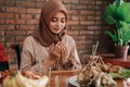 Woman open her palm and pray before eating