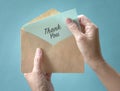 Woman open and look at thank you card or note inside a brown envelope Royalty Free Stock Photo