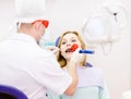 woman with open mouth receiving dental filling dry