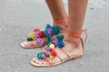 Woman with open orange sandals with fabric decoration before Fendi fashion show, Milan Fashion Week street