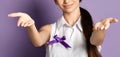 Woman with open palms hands with purple ribbon to world epilepsy day. Alzheimer`s disease, pancreatic cancer