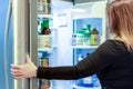 Woman with open refrigerator