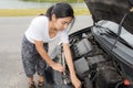 Woman opened the hood Broken car on the side