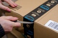 Soest, Germany - December 12, 2018: Woman Opening Amazon Prime package Royalty Free Stock Photo