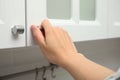 Woman opening cabinet door at home, closeup Royalty Free Stock Photo