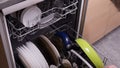 Woman opening dishwasher