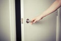 Woman opening a door at night Royalty Free Stock Photo