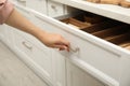 Woman opening drawer in kitchen, closeup view Royalty Free Stock Photo