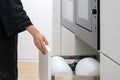 Woman opening drawer with plates and dishes Royalty Free Stock Photo