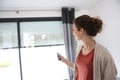 Woman opening electric shutters