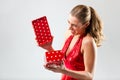 Woman opening the gift and is happy Royalty Free Stock Photo