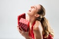 Woman opening the gift and is happy Royalty Free Stock Photo