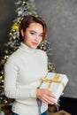 Woman opening gifts at christmas tree with gifts for new year Royalty Free Stock Photo