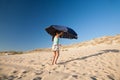 Woman opening parasol at beach Royalty Free Stock Photo