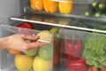 Woman opening refrigerator drawer with fresh fruits Royalty Free Stock Photo