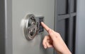 Woman opening steel safe with electronic lock